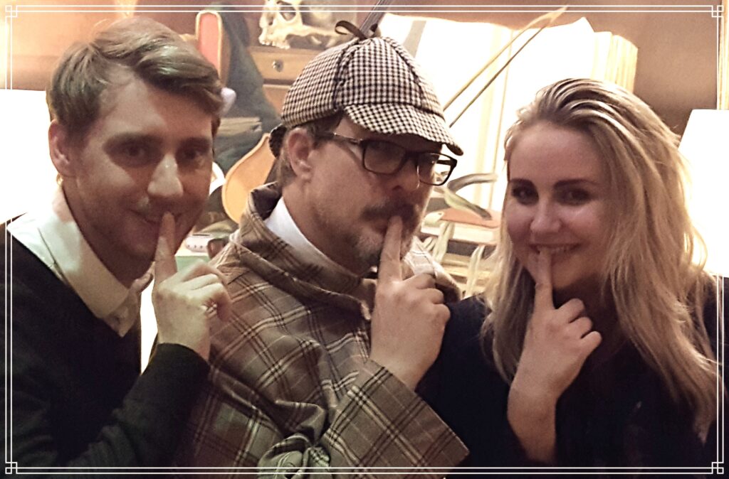 Guests joining a Sherlock Holmes character in a murder mystery