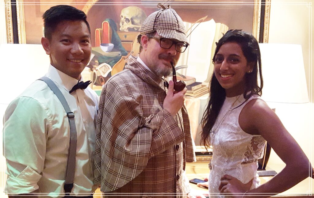 Sherlock Holmes character with guests at a Murder Mystery Events party